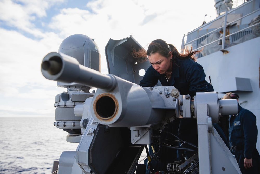 Sailor conducts maintenance on the 25mm gun