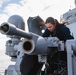 Sailor conducts maintenance on the 25mm gun