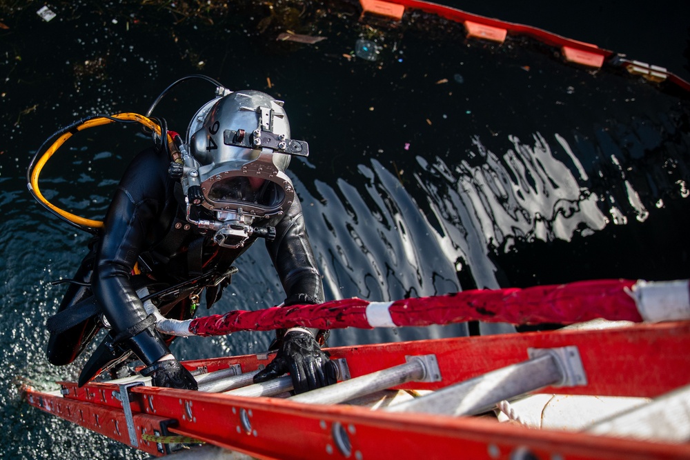 Sailor performs maintenance on USS John S. McCain