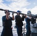 Sailors conduct maintenance on the 25mm gun