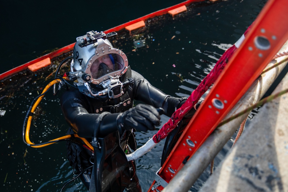 Sailor performs maintenance on USS John S. McCain