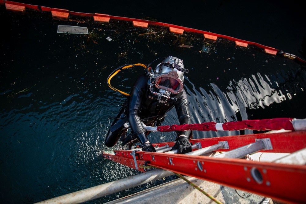 Sailor performs maintenance on USS John S. McCain