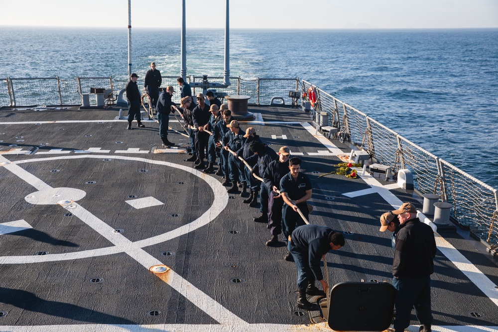 Sailors heave a mooring line