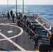 Sailors heave a mooring line