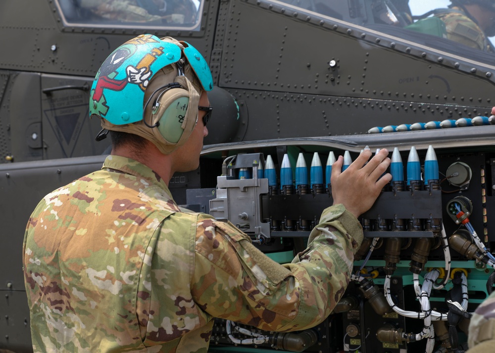 U.S. Army soldiers reload ammo during aerial gunnery