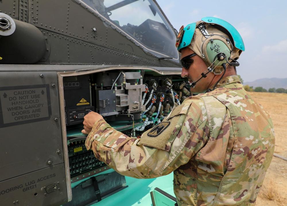 U.S. Army Soldiers reload ammo during aerial gunnery