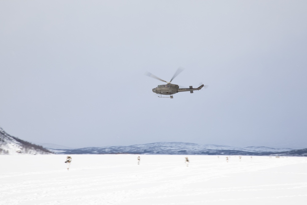 Huey Flies Over U.S. Soldiers