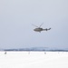 Huey Flies Over U.S. Soldiers