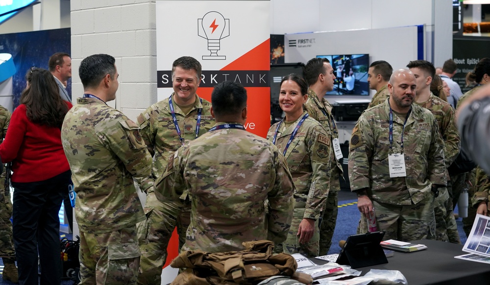 Spark Tank Finalists interact while attending the AFWERX's booth