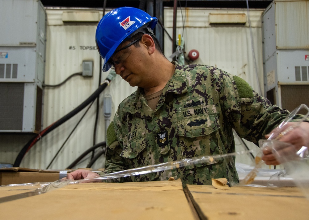 USS Ronald Reagan (CVN 76) Sailors sort and process mail