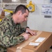 USS Ronald Reagan (CVN 76) Sailors sort and process mail