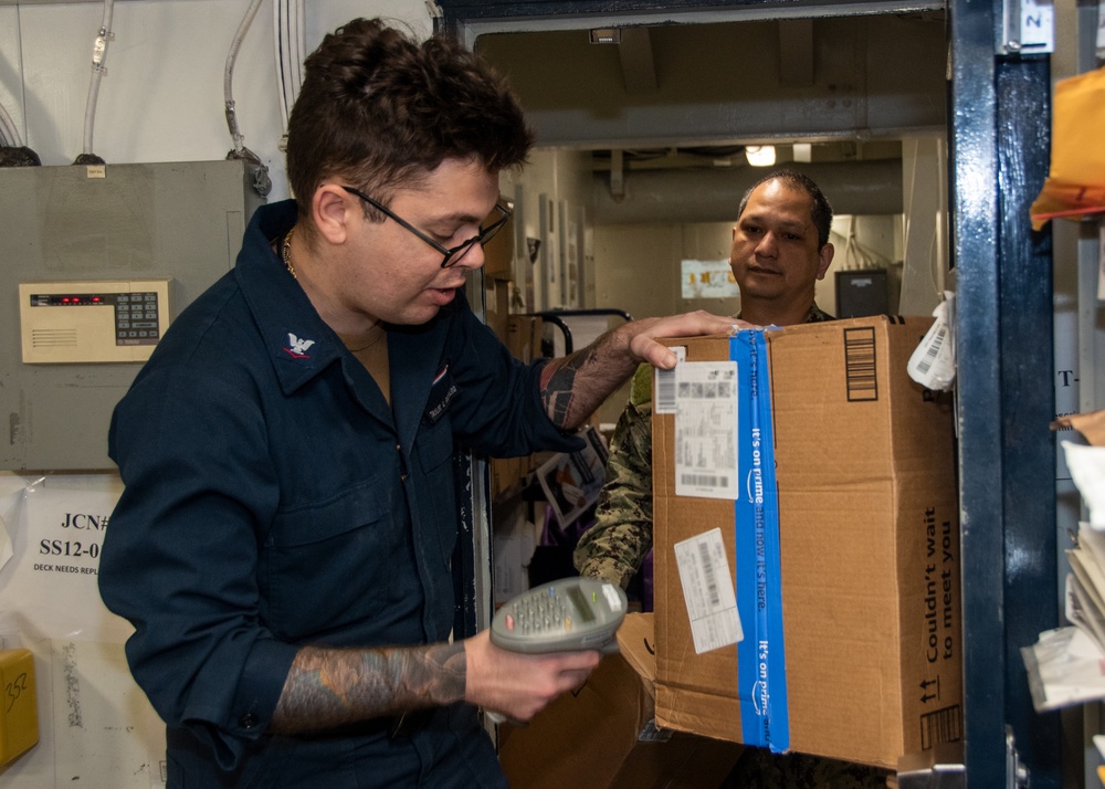 USS Ronald Reagan (CVN 76) Sailors sort and process mail