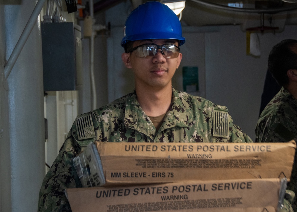 USS Ronald Reagan (CVN 76) Sailors sort and process mail