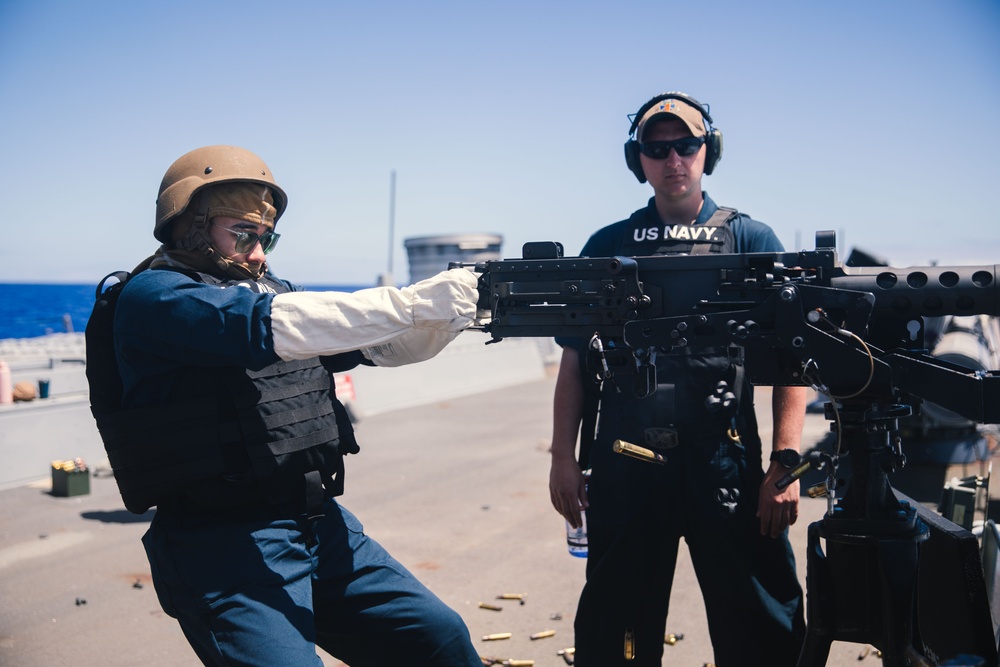Sailor fires M2HB machine gun