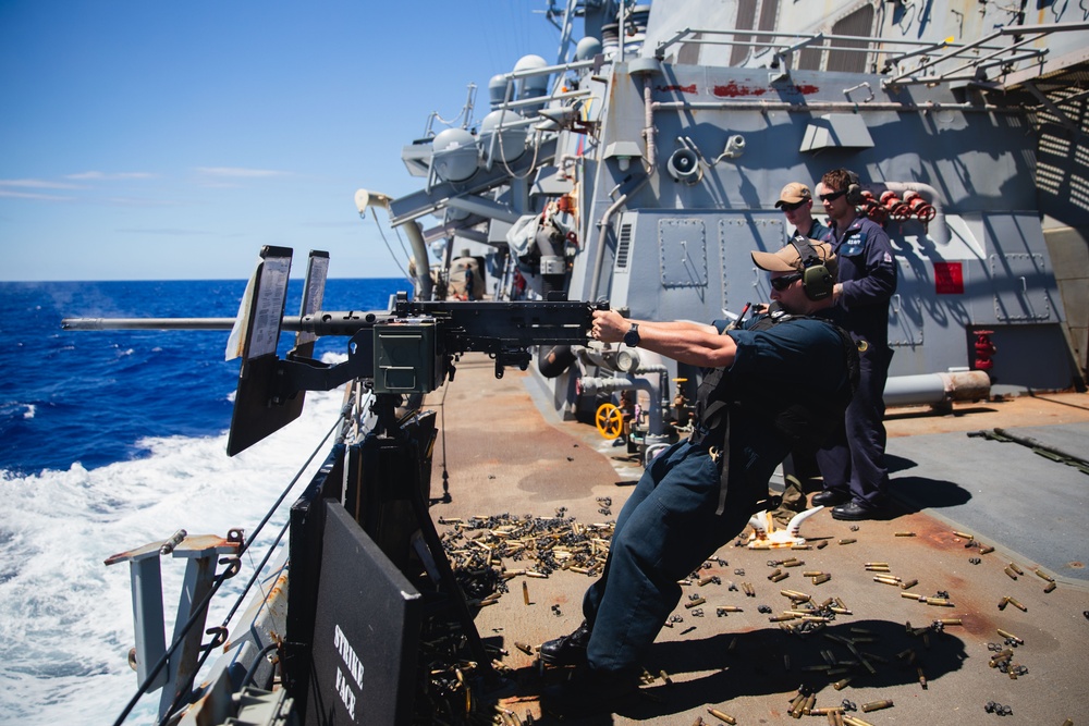 Sailor fires M2HB machine gun