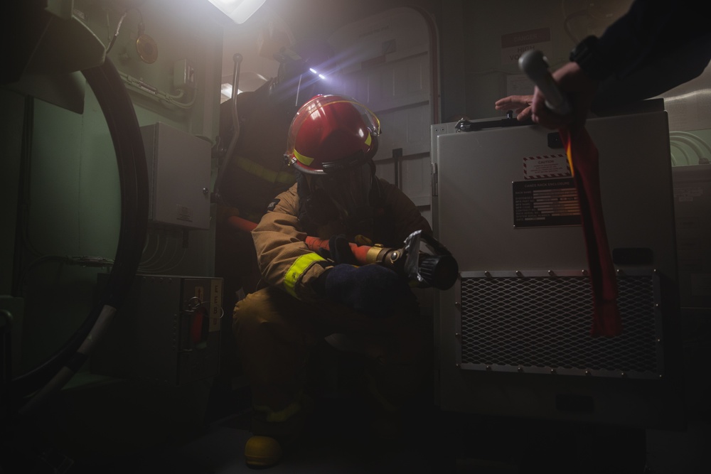 Sailors battle a simulated fire during a general quarters drill