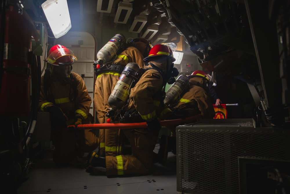 Sailors battle a simulated fire during a general quarters drill