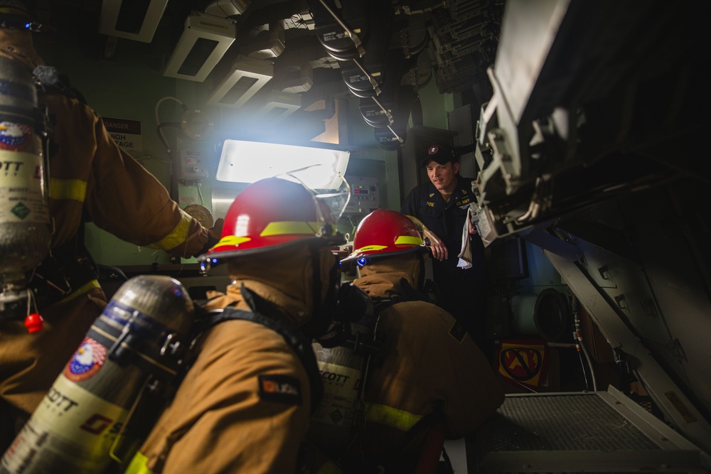 Sailors battle a simulated fire during a general quarters drill