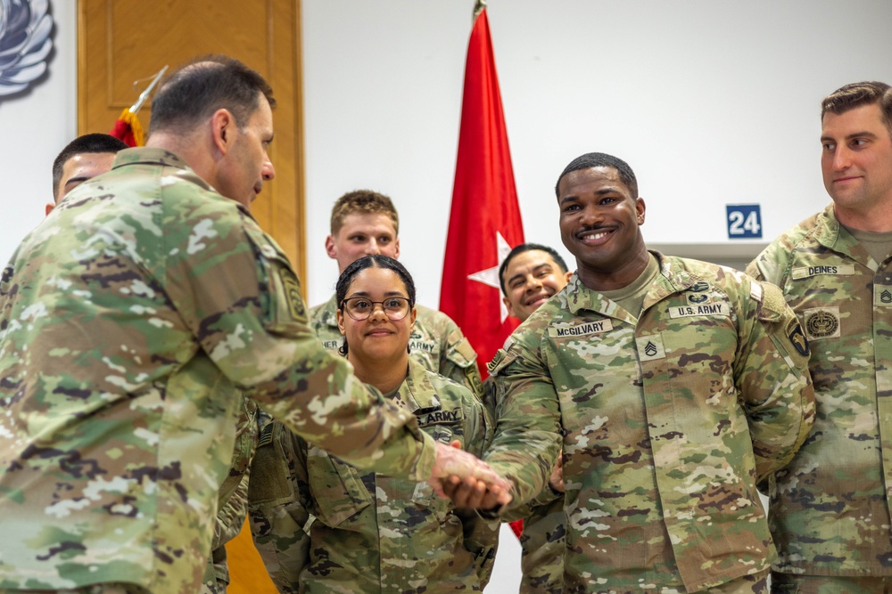 Lt. Gen. Chistopher Donahue awards Soldiers with a Challenge Coin