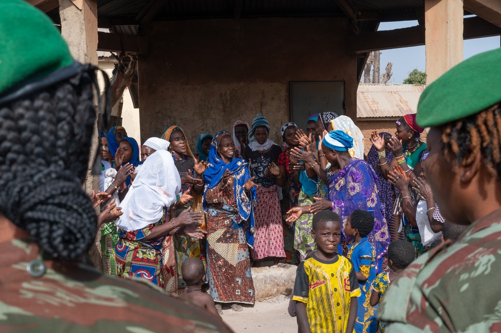 U.S. Army soldiers with the 91st Civil Affairs Battalion deployed with Special Operations Command Africa, conduct a civil engagement with Forces des Armées Beninoises members