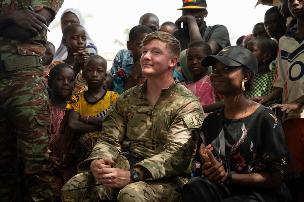 U.S. Army soldiers with the 91st Civil Affairs Battalion deployed with Special Operations Command Africa, conduct a civil engagement with Forces des Armées Beninoises members