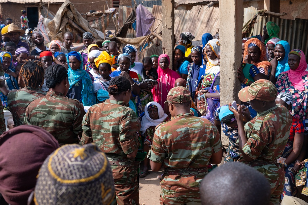 U.S. Army soldiers with the 91st Civil Affairs Battalion deployed with Special Operations Command Africa, conduct a civil engagement with Forces des Armées Beninoises members