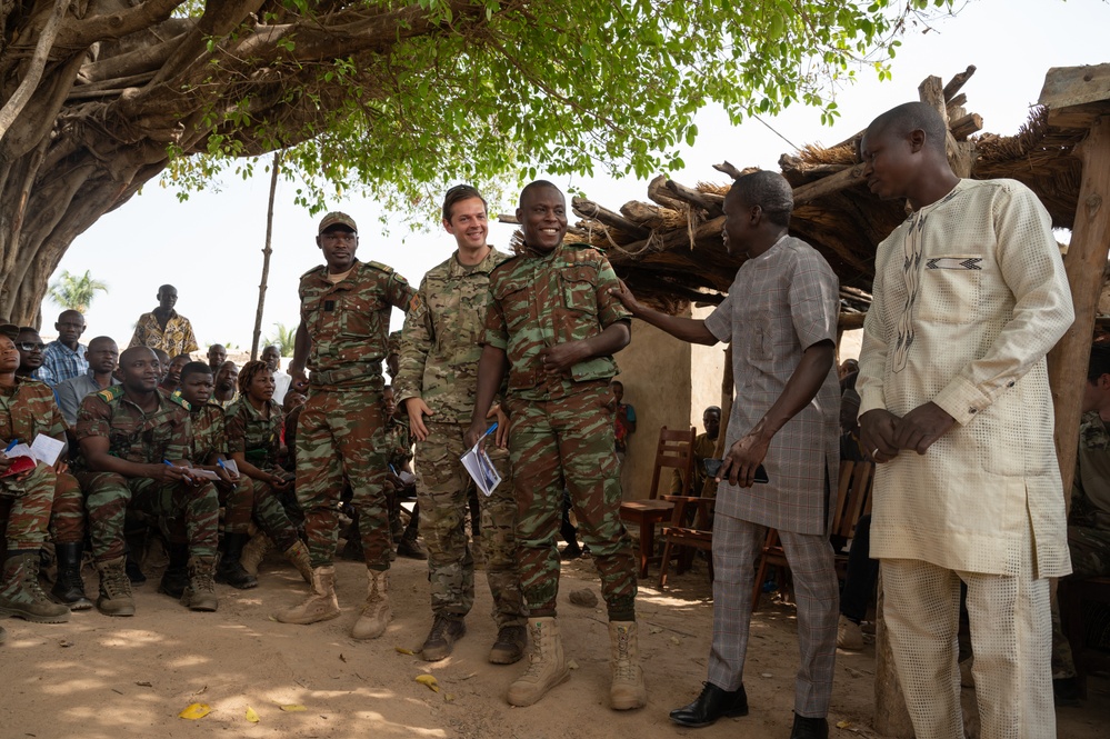 U.S. Army soldiers with the 91st Civil Affairs Battalion deployed with Special Operations Command Africa, conduct a civil engagement with Forces des Armées Beninoises members