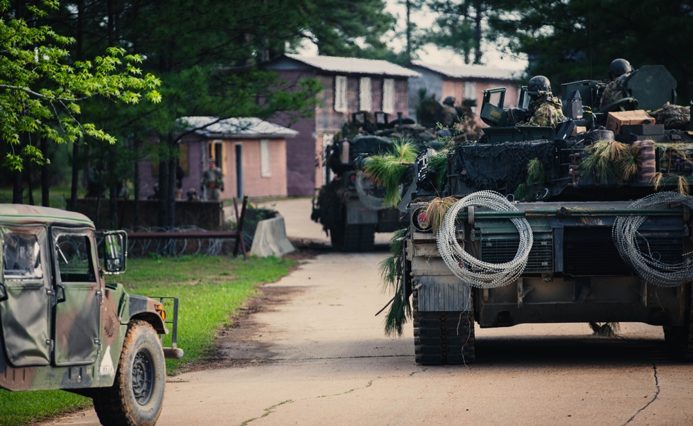 Armored units support infantry at the Joint Readiness Training Center