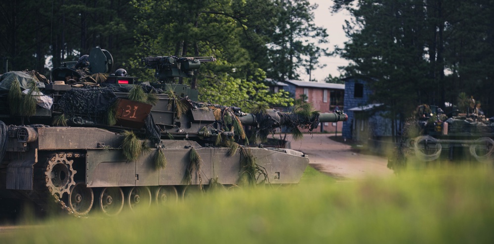 Armored units support infantry at the Joint Readiness Training Center