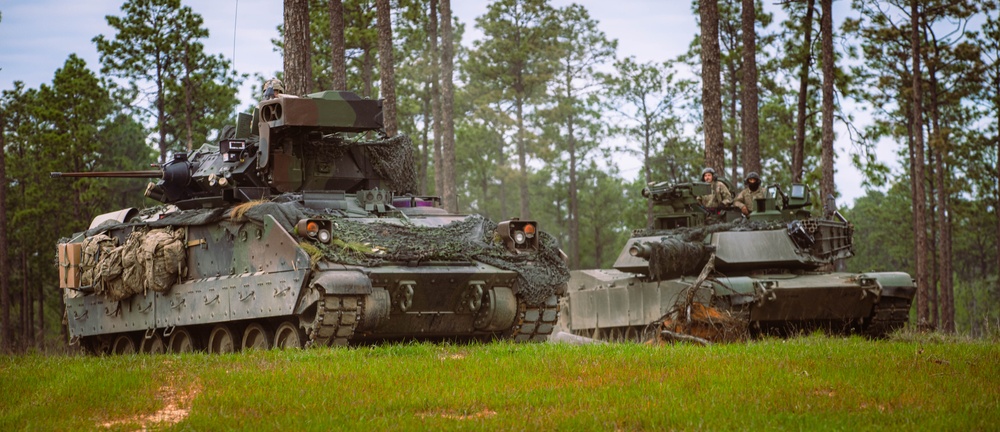 Armored units support infantry at the Joint Readiness Training Center