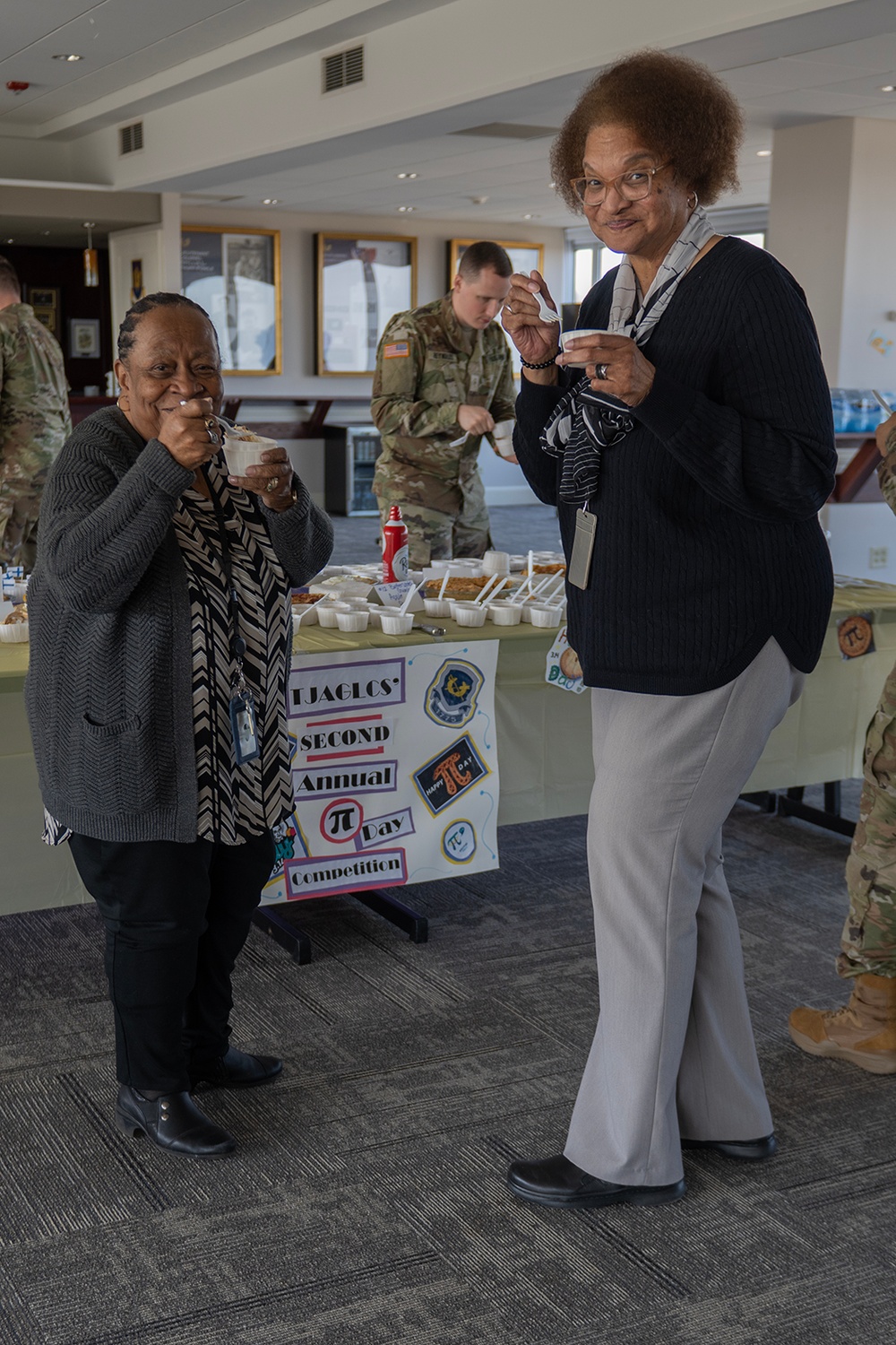 Photo By Billie Suttles | Linda Cuffee, The Judge Advocate General's Legal Center and School's Continuing Legal Education Administrator, (right) and Barbara Wood, Tricare Specialist, (left) sample some entries during the annual TJAGLCS Pi Day Contest on March 14.
