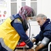 An EMS volunteer for the White Helmets conducts health screenings for a patient in northwest Syria.
