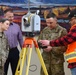 Alaska District's Geomatics Section presents surveying equipment to staff during National Surveyors Week