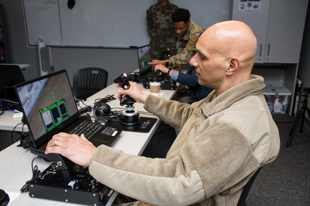 Lt. Gen. Robinson Tests Flight Simulator at OTS Multi-Domain Lab, Emphasizes Leadership Skills in Officer Training