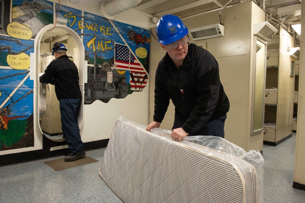 USS John C. Stennis (CVN 74) Sailors unpack mattresses