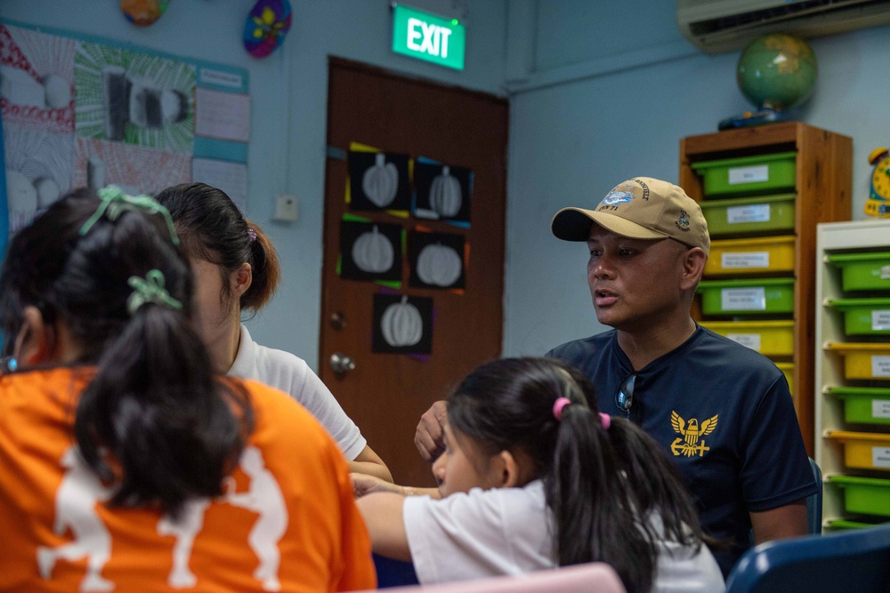 Theodore Roosevelt Sailors Conduct COMRELs in Singapore