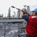 Sailors aboard the USS Howard conduct a replenishment-at-sea with USNS Yukon in the Philippine Sea
