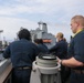 Sailors aboard the USS Howard conduct a replenishment-at-sea with USNS Yukon in the Philippine Sea