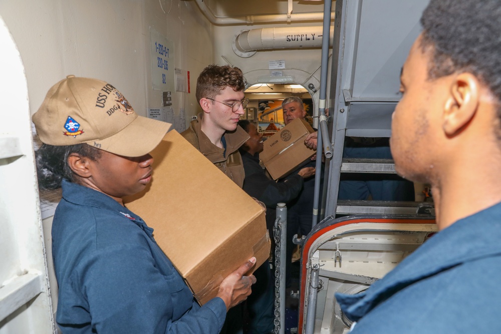 Sailors aboard the USS Howard conduct a replenishment-at-sea with USNS Yukon in the Philippine Sea