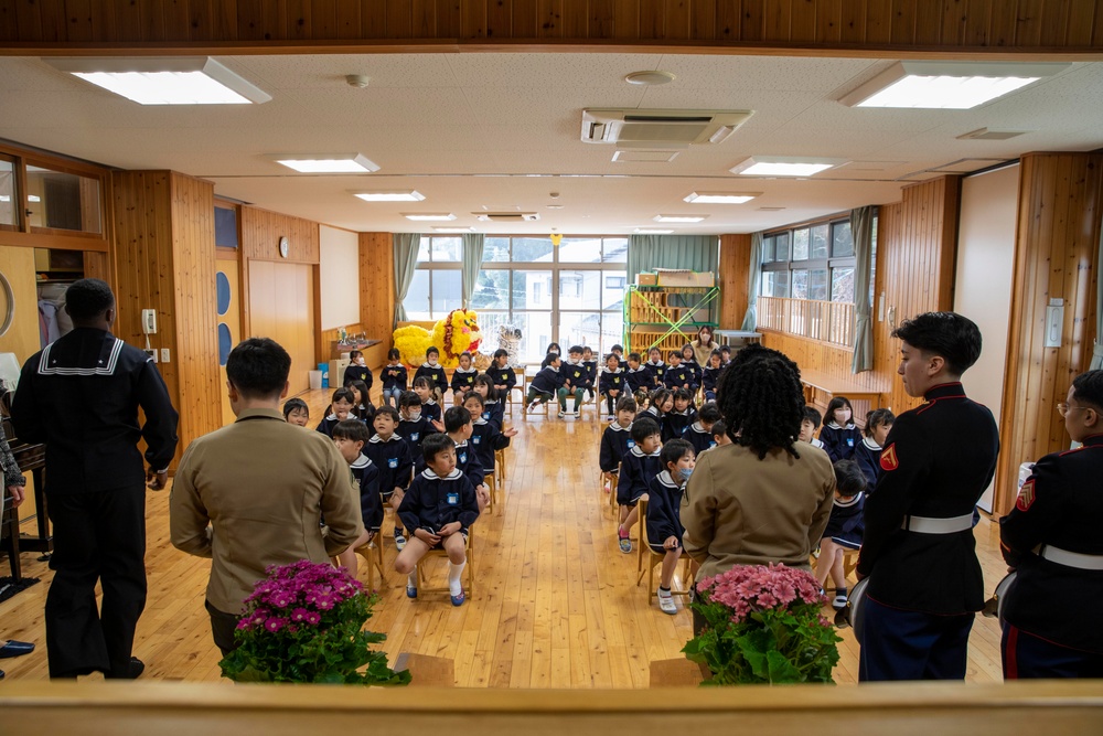 Graduation: Volunteers from Marine Corps Air Station Iwakuni hand out graduation certificates