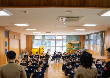 Graduation: Volunteers from Marine Corps Air Station Iwakuni hand out graduation certificates