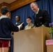 Graduation: Volunteers from Marine Corps Air Station Iwakuni hand out graduation certificates