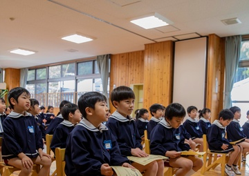 Graduation: Volunteers from Marine Corps Air Station Iwakuni hand out graduation certificates