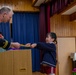 Graduation: Volunteers from Marine Corps Air Station Iwakuni hand out graduation certificates