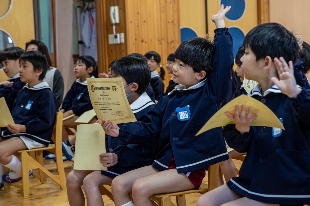 Graduation: Volunteers from Marine Corps Air Station Iwakuni hand out graduation certificates