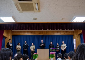 Graduation: Volunteers from Marine Corps Air Station Iwakuni hand out graduation certificates