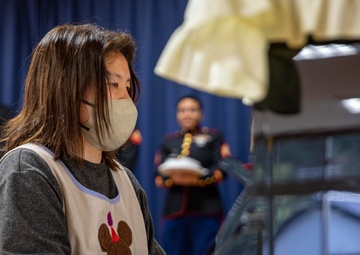 Graduation: Volunteers from Marine Corps Air Station Iwakuni hand out graduation certificates