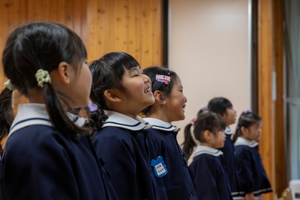 Graduation: Volunteers from Marine Corps Air Station Iwakuni hand out graduation certificates