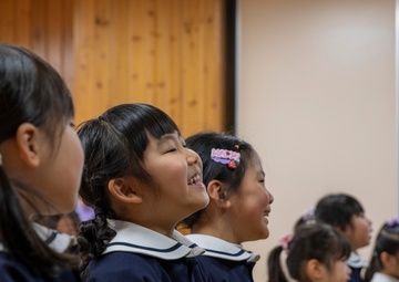 Graduation: Volunteers from Marine Corps Air Station Iwakuni hand out graduation certificates