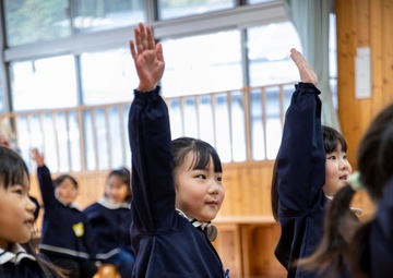 Graduation: Volunteers from Marine Corps Air Station Iwakuni hand out graduation certificates